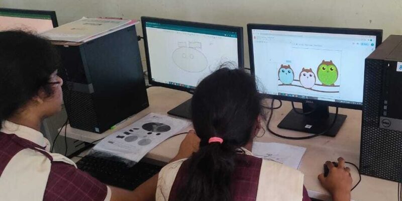 Students using computers in a classroom.