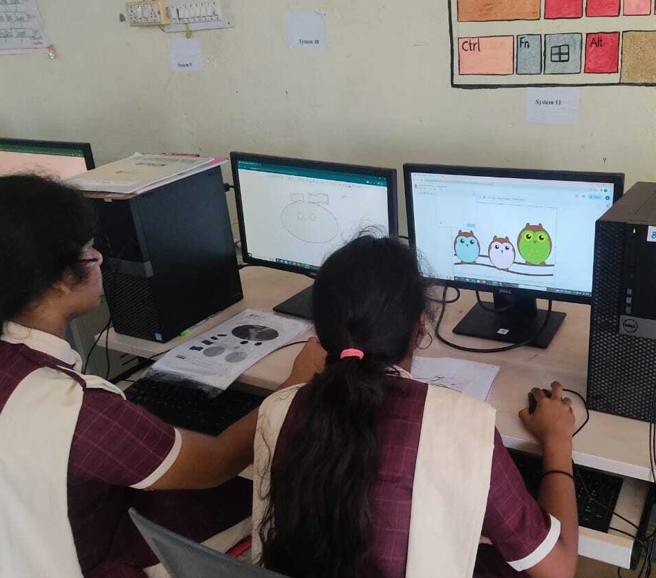 Students using computers in a classroom.