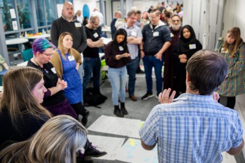 Photo of educators and researchers collaborating at the AI symposium.