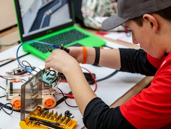 Young adult with a physical computing project.