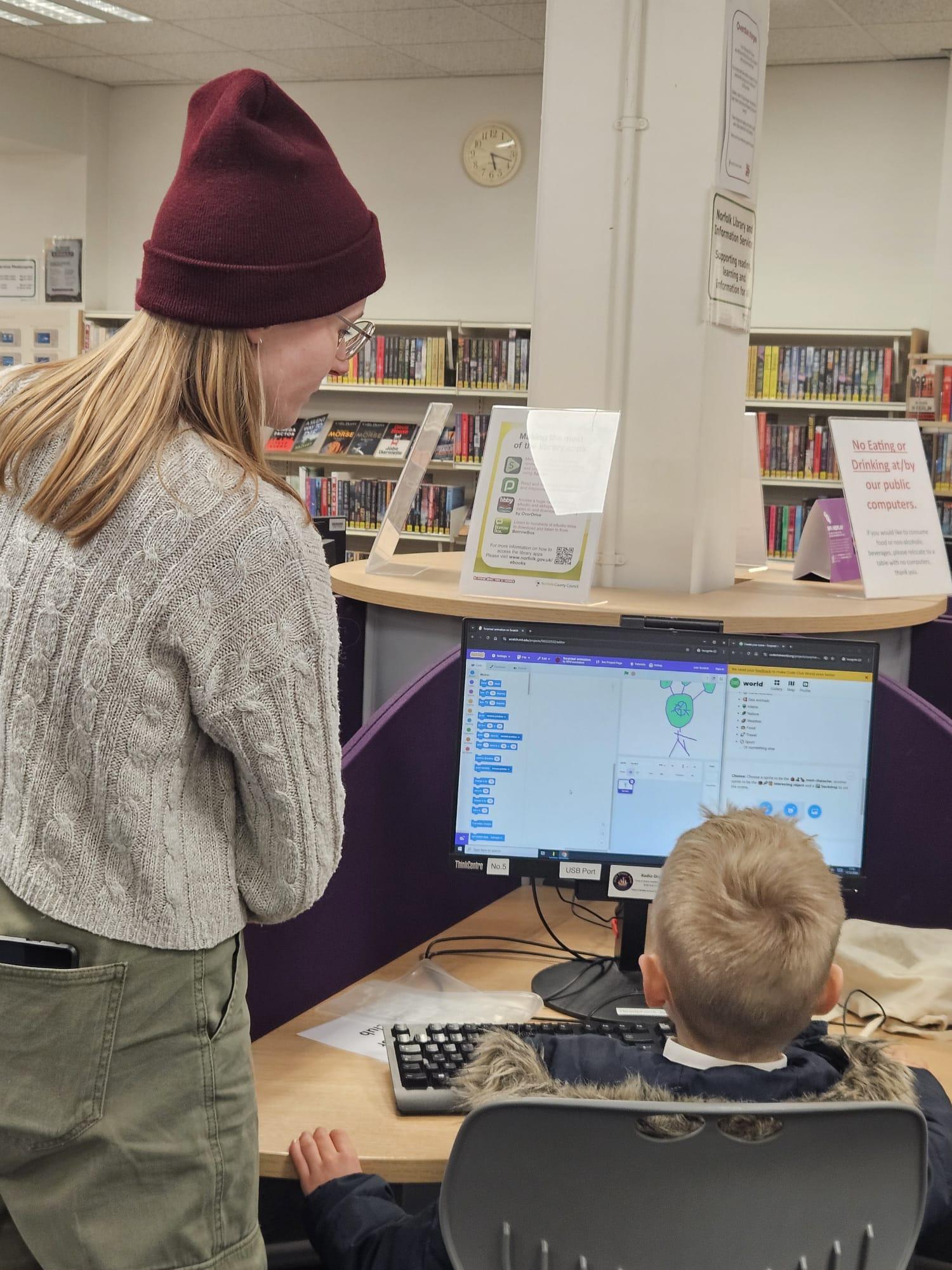 A mentor is helping a student in class.