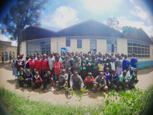 A group of young people outside a school.