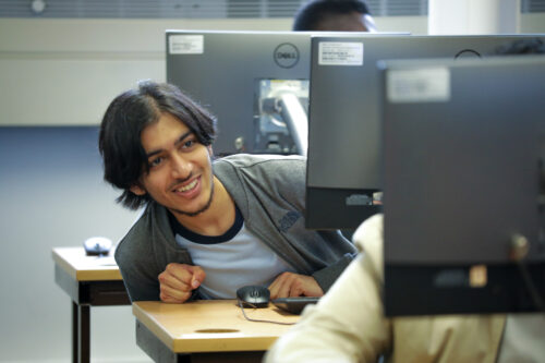 A student in a computing classroom.