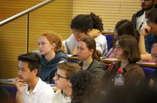 Students attend a lecture at a university.