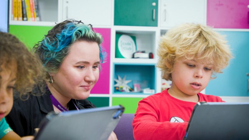 A child and Code Club leader at a club session.