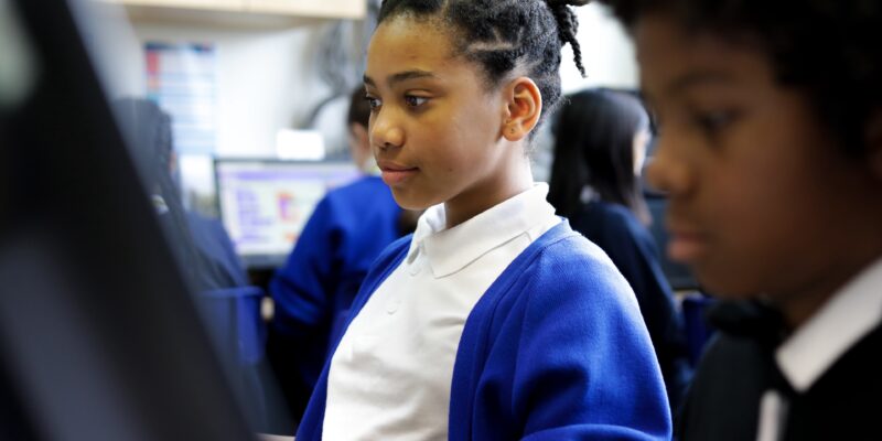 Two learners in a computing classroom.