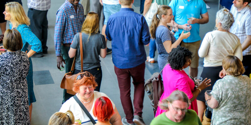 Educators and researchers mingle at a conference.