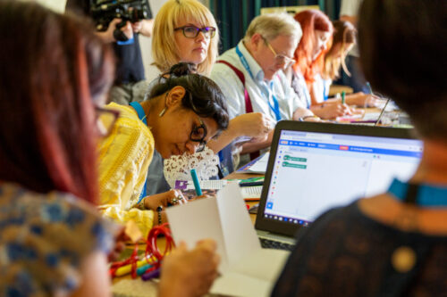 Workshop attendees at a table.