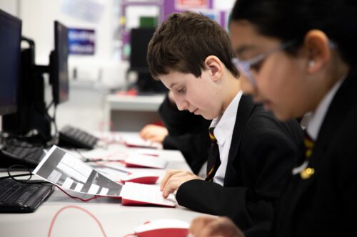 Secondary school age learners in a computing classroom.