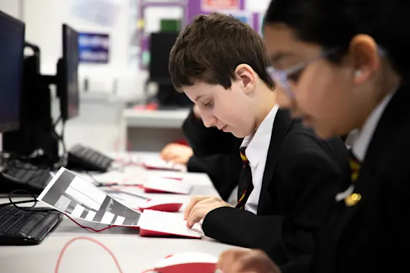 Students following instructions during a computing lesson