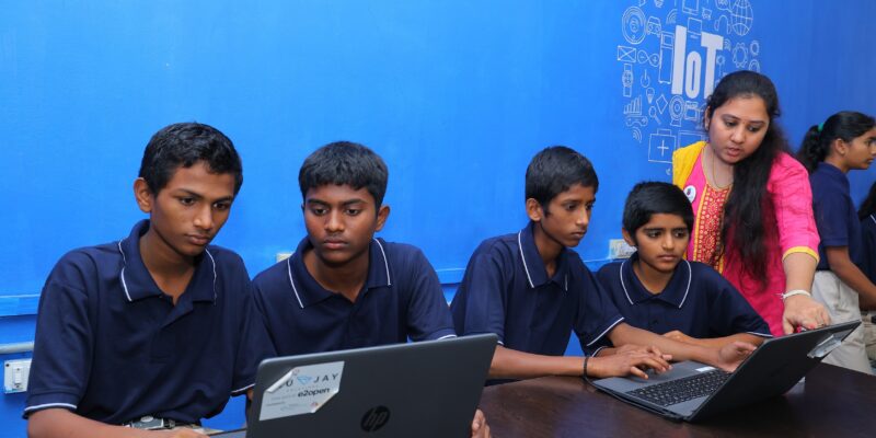 A group of students and a teacher at the Coding Academy in Telangana.