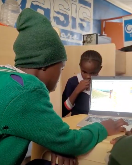 A young learner coding on a laptop.