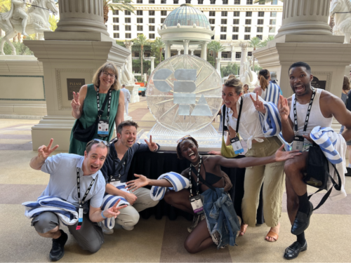 A group of educators standing outside a conference venue. 