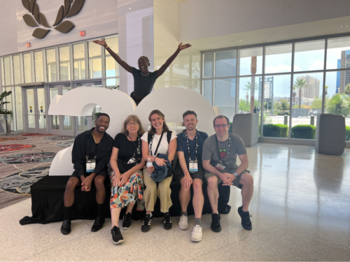 A team of 6 educators inside a conference hall. 