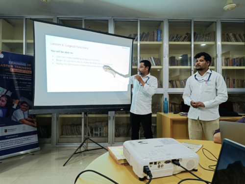 Two master teachers are delivering a presentation to teachers. 